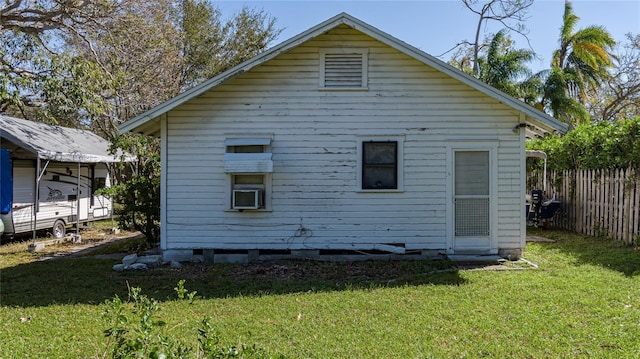 rear view of house featuring a yard