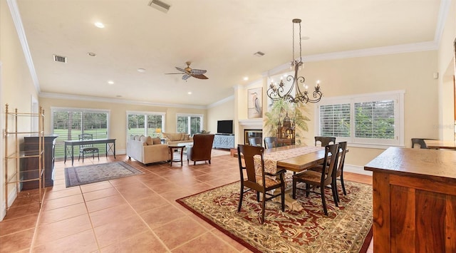 tiled dining space with crown molding and ceiling fan with notable chandelier