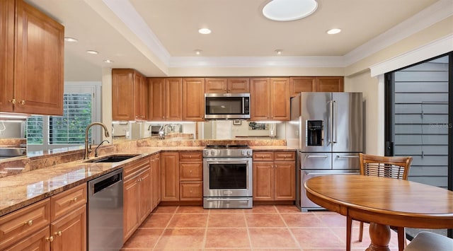 kitchen with light stone counters, light tile patterned floors, ornamental molding, sink, and stainless steel appliances