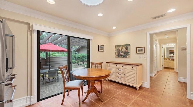 dining space featuring crown molding and tile patterned floors