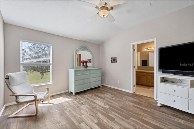 unfurnished room featuring a textured ceiling, vaulted ceiling, wood-type flooring, and ceiling fan