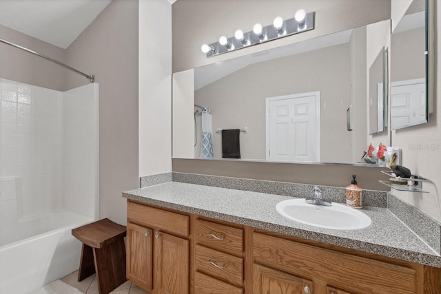 bathroom featuring vanity, tile patterned flooring, vaulted ceiling, and shower / tub combo