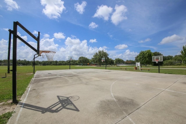 view of sport court featuring a yard