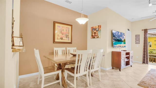 tiled dining area with ceiling fan