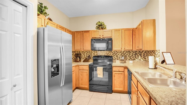 kitchen with decorative backsplash, black appliances, sink, and light tile patterned floors