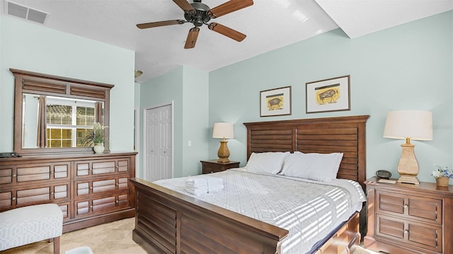 bedroom with a closet, ceiling fan, and a textured ceiling