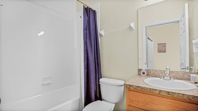 full bathroom with vanity, shower / tub combo with curtain, and toilet