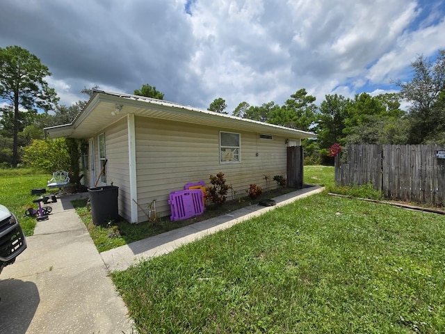 view of property exterior with a yard