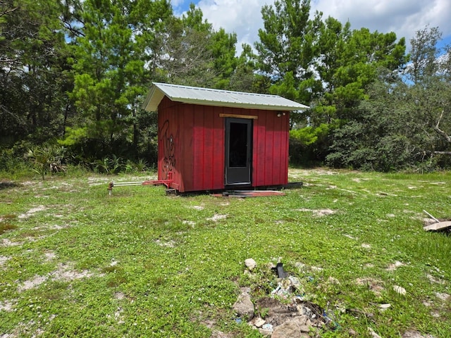 view of outdoor structure featuring a lawn