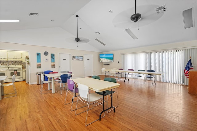 dining area featuring ceiling fan, light wood-type flooring, and lofted ceiling