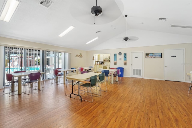 interior space with ceiling fan, vaulted ceiling, and light hardwood / wood-style flooring