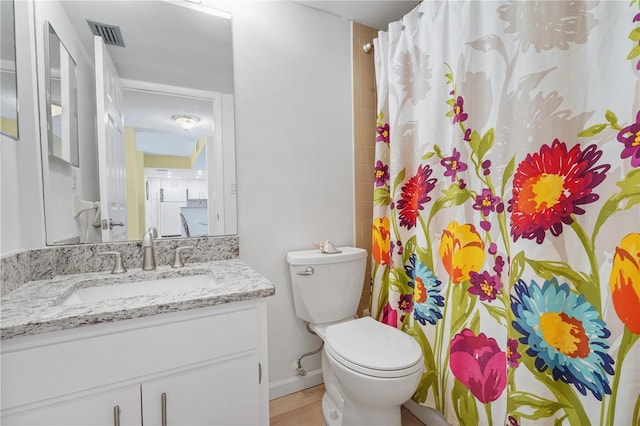 bathroom featuring visible vents, a shower with shower curtain, vanity, and toilet