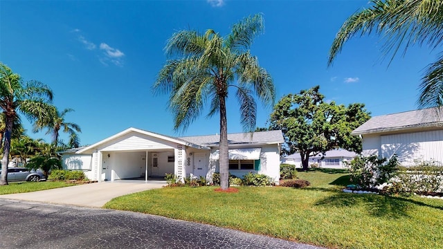 single story home featuring a front lawn and a carport