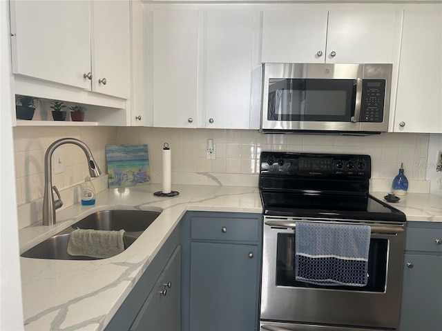 kitchen featuring white cabinetry, stainless steel appliances, and sink