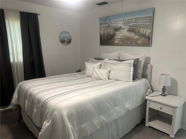 bedroom with dark hardwood / wood-style flooring