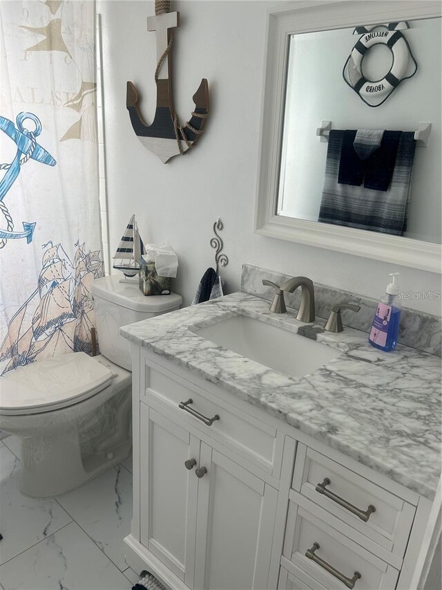 bathroom featuring curtained shower, toilet, marble finish floor, and vanity