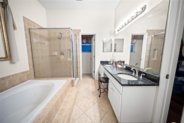 bathroom featuring vanity, independent shower and bath, and tile patterned flooring