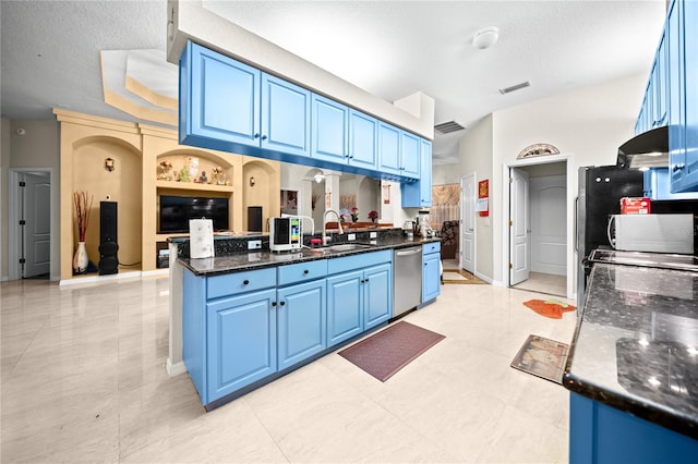 kitchen featuring stainless steel dishwasher, a textured ceiling, blue cabinets, and sink