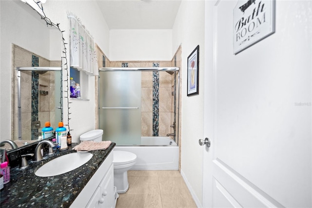 full bathroom featuring vanity, combined bath / shower with glass door, toilet, and tile patterned flooring