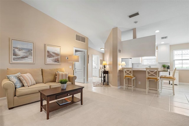 carpeted living room featuring lofted ceiling