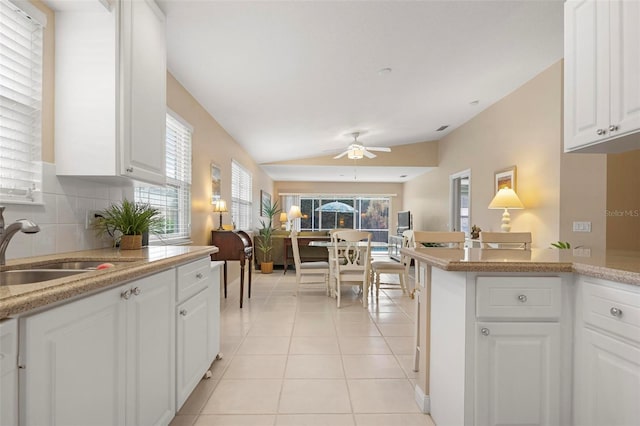 kitchen with white cabinetry, ceiling fan, and plenty of natural light