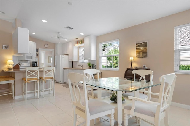 dining space featuring plenty of natural light, ceiling fan, and light tile patterned flooring