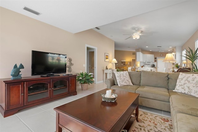 tiled living room with ceiling fan