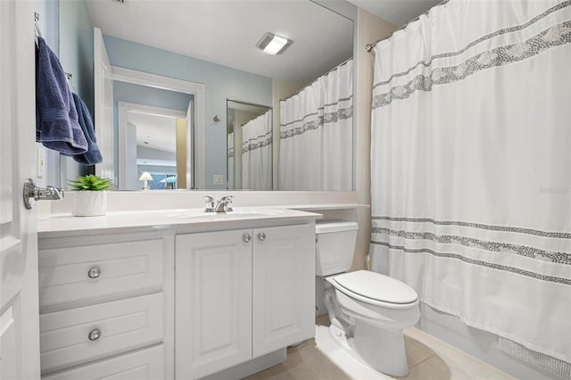 full bathroom with shower / bath combo with shower curtain, tile patterned floors, vanity, and toilet