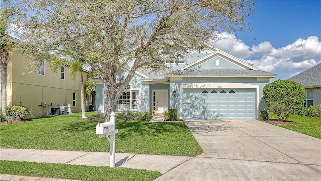 view of front of property featuring a front yard and a garage