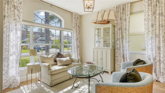 sitting room featuring light hardwood / wood-style floors and a notable chandelier