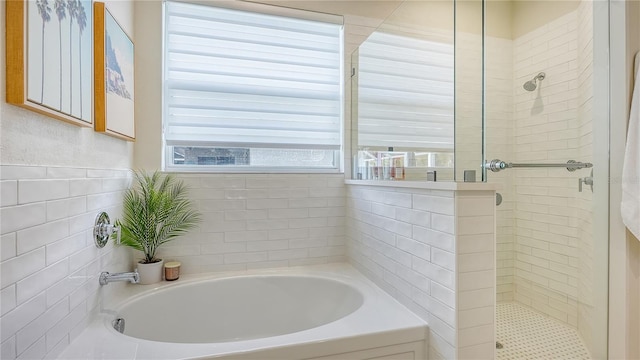 bathroom featuring shower with separate bathtub