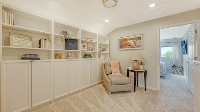 living area featuring lofted ceiling and light colored carpet