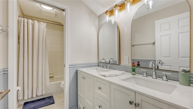 full bathroom featuring vanity, shower / tub combo with curtain, toilet, and tile patterned floors