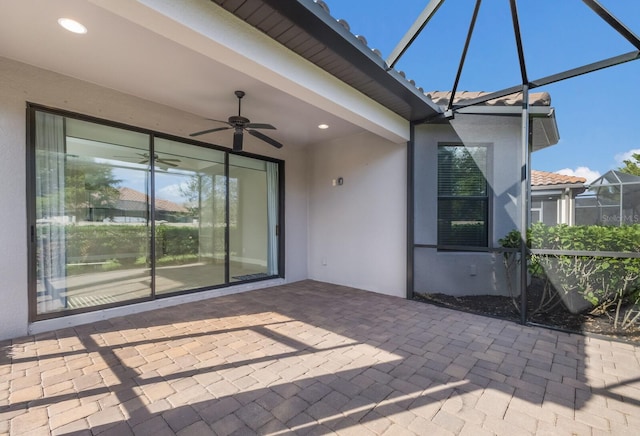 view of patio / terrace with glass enclosure and ceiling fan