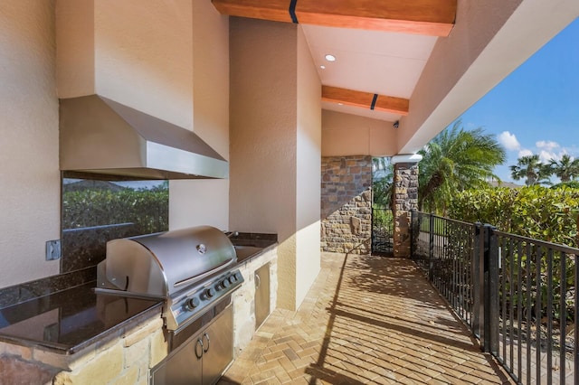 view of patio with area for grilling and a grill