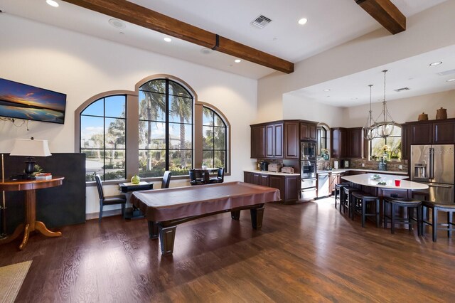 dining room with dark hardwood / wood-style floors, beam ceiling, a high ceiling, and pool table