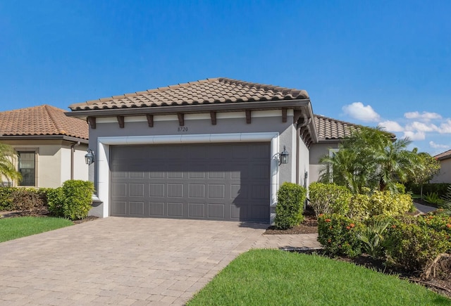 mediterranean / spanish-style home with a garage