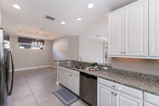 kitchen featuring white cabinets, stainless steel appliances, a raised ceiling, and sink