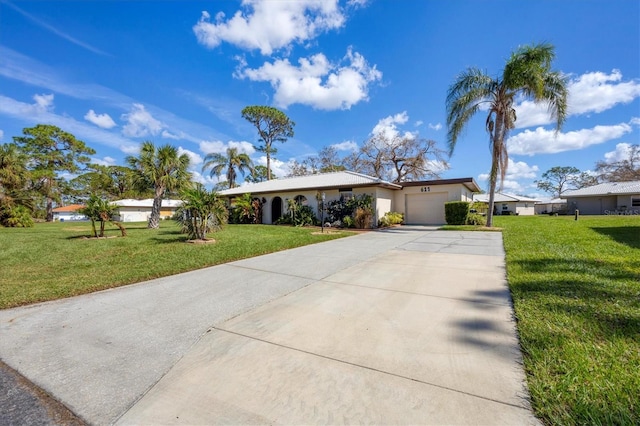 single story home featuring a front lawn and a garage