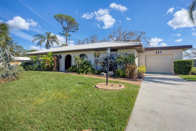 view of front of property featuring a front lawn and a garage