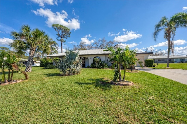 view of front of property with a front lawn and a garage