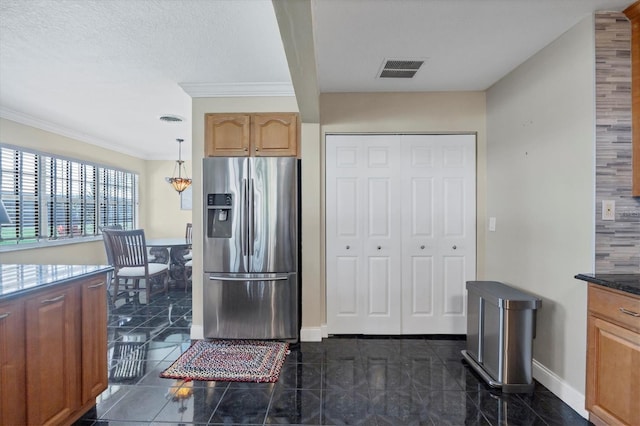 kitchen featuring crown molding, a textured ceiling, stainless steel fridge with ice dispenser, and decorative light fixtures