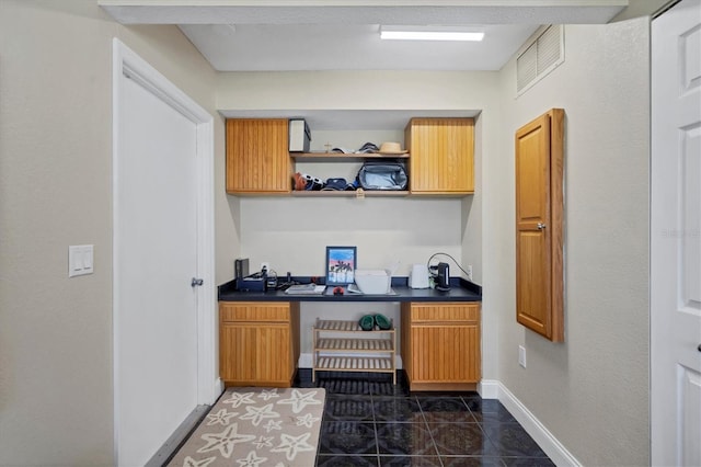 kitchen featuring dark tile patterned flooring