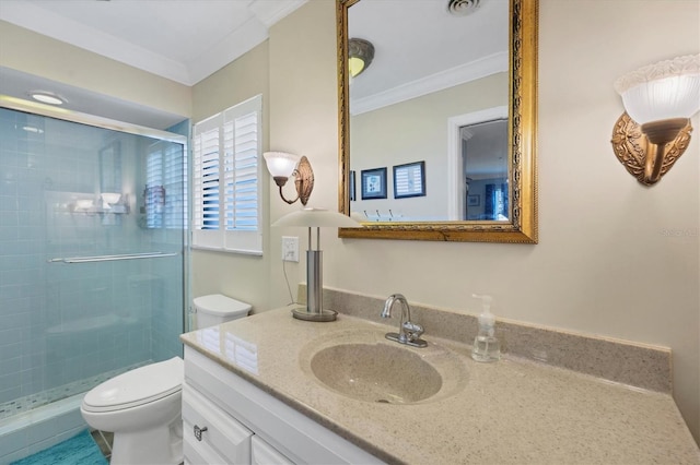 bathroom featuring vanity, crown molding, toilet, and an enclosed shower