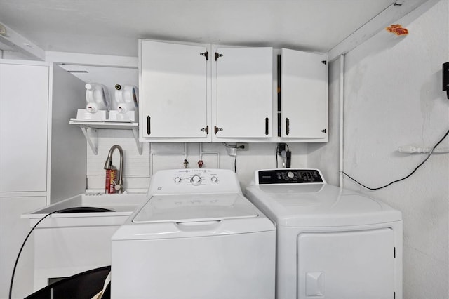 laundry area featuring cabinets and washing machine and clothes dryer