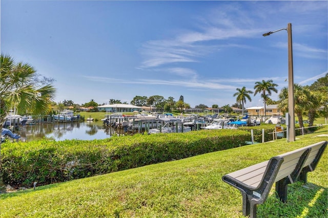 view of dock featuring a water view and a lawn