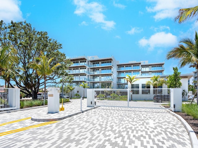 4651 Gulf Of Mexico Dr Unit 402, Longboat Key, FL 34228 - view of apartment building / complex featuring fence
