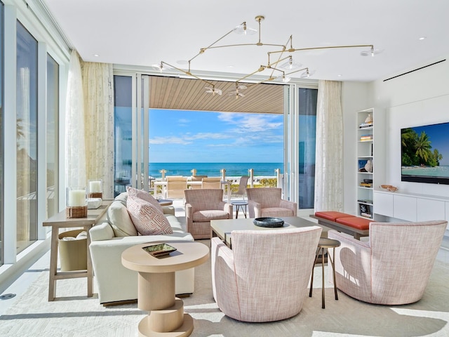 living room featuring light colored carpet, a wall of windows, and a notable chandelier