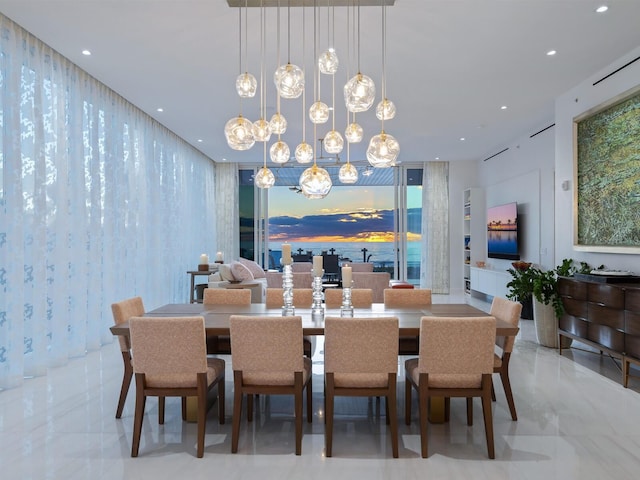 dining room with a healthy amount of sunlight and an inviting chandelier