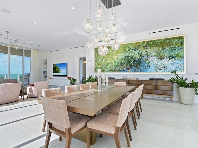 dining room with a water view and an inviting chandelier